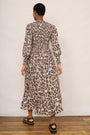 Back view of a model in a snake leopard print midi dress.