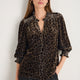 Model wearing Alina leopard print blouse, front view