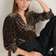 Woman wearing Alina leopard print silk velvet blouse