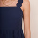 Close-up showing square neckline, scallop trim on straps and bodice of blue midi dress