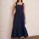 Full length view of woman posing in dark blue cotton seersucker midi dress