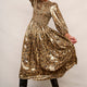 Model standing outdoors wearing a gold-toned leopard print metallic dress.