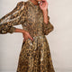Close up of the neckline, smocked bodice, and sleeve detail of the leopard print lame dress.