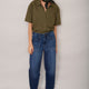 Full length front view of khaki shirt worn with blue jeans.