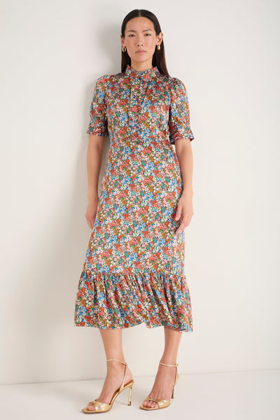 Model standing, wearing the floral midi Fabienne silk dress.