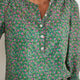 Detailed view of the blouse button placket and floral print pattern.