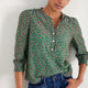 Model showing the 3/4 sleeve fit and gather detailing on the floral blouse.