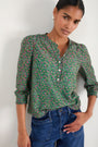 Model showing the 3/4 sleeve fit and gather detailing on the floral blouse.