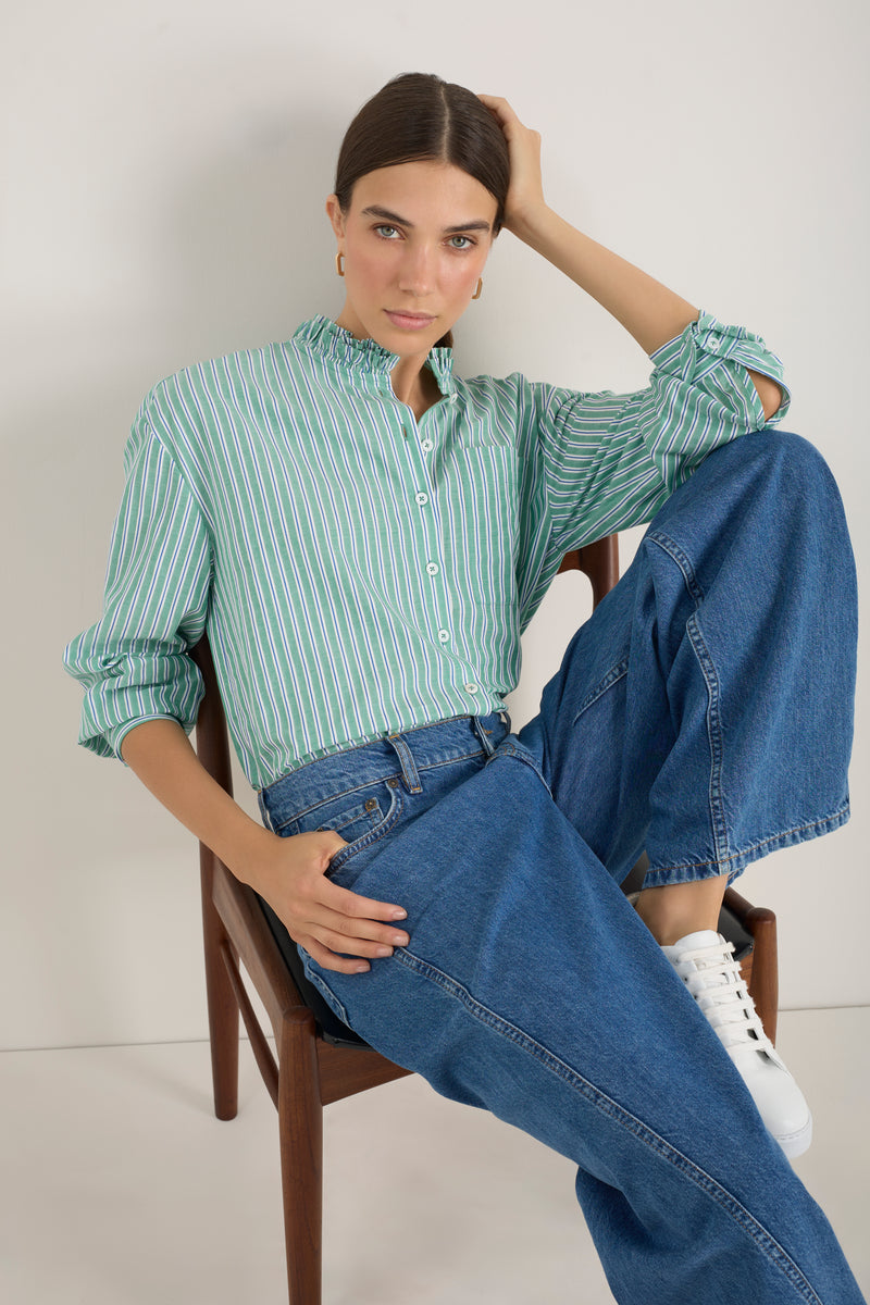 Model wearing a green, cobalt, and ivory striped cotton shirt.