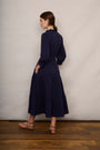 Back view of model in navy tiered jersey dress
