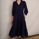 Model standing in navy tiered jersey midi dress