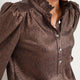 Model wearing the cocoa metallic frill neck top.