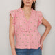 Portrait of woman in pink embroidered Talya top