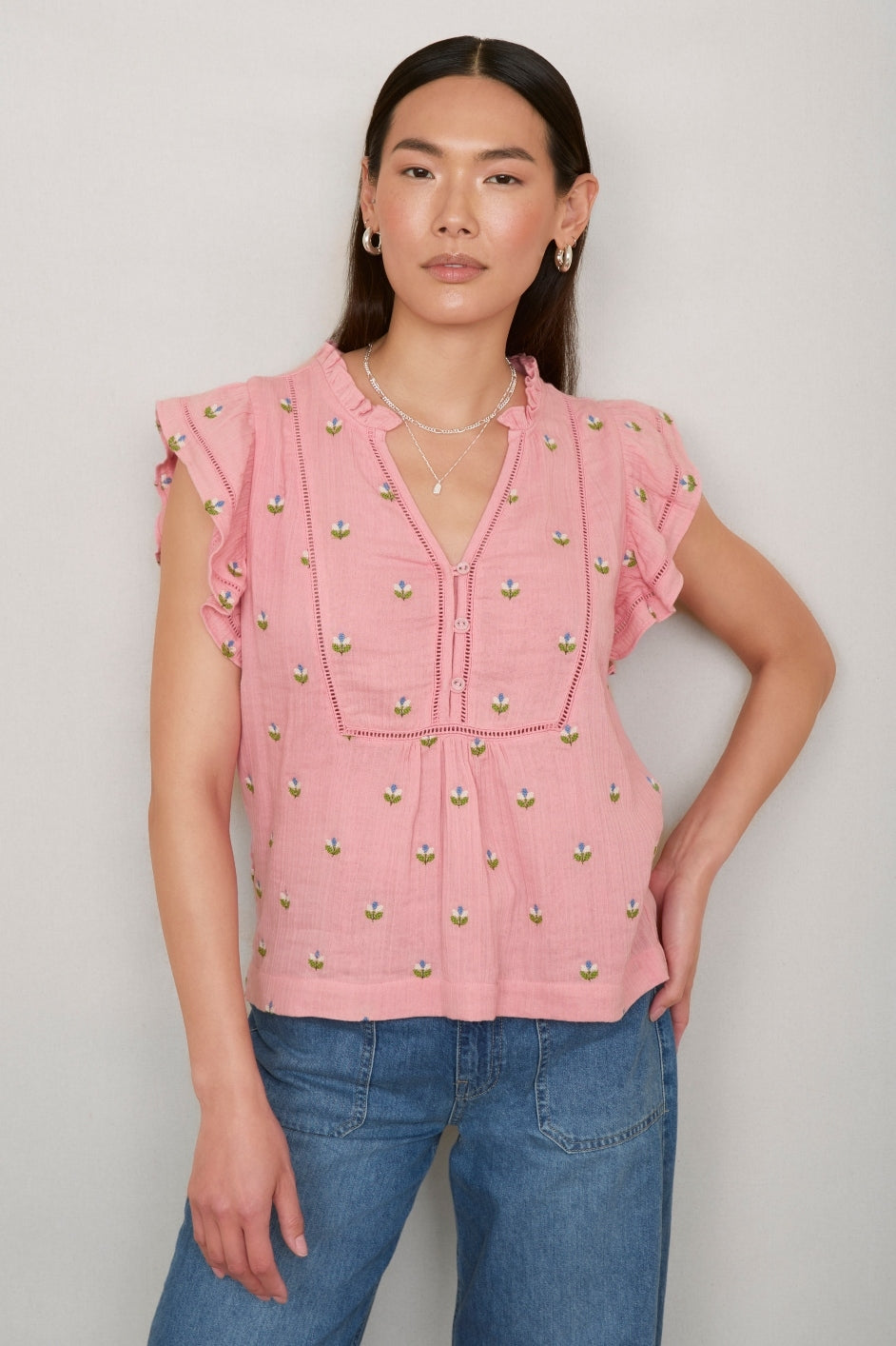 Portrait of woman in pink embroidered Talya top