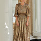Studio portrait of a model in a leopard print party dress with long blouson sleeves.