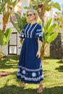 Flat lay of the Drew embroidered navy dress against a neutral background.